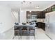 Modern kitchen with dark cabinetry, granite countertops, stainless steel appliances, and island at 3196 Crown Jewel Ct, Winter Park, FL 32792