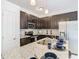 Modern kitchen with dark cabinetry, granite countertops, and stainless steel appliances at 3196 Crown Jewel Ct, Winter Park, FL 32792