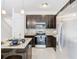 Modern kitchen with dark cabinetry, granite countertops, and stainless steel appliances at 3196 Crown Jewel Ct, Winter Park, FL 32792