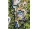 Aerial view of a house with solar panels, pool, and detached garage, surrounded by trees at 3290 Red Fox Dr, Deltona, FL 32725