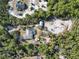 Aerial view of a house with solar panels, pool, and detached garage, surrounded by lush greenery at 3290 Red Fox Dr, Deltona, FL 32725