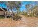 Landscaped backyard with shed and wheelbarrow at 3290 Red Fox Dr, Deltona, FL 32725