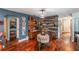 Rustic dining area with wood floors and a unique wall feature at 3290 Red Fox Dr, Deltona, FL 32725