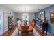 Farmhouse-style dining room with wooden table and blue accent wall at 3290 Red Fox Dr, Deltona, FL 32725