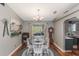 A farmhouse-style dining room with a wooden table and white chairs at 3290 Red Fox Dr, Deltona, FL 32725