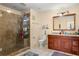 Bathroom featuring a glass-enclosed shower and a double sink vanity with dark wood cabinets at 36129 E Eldorado Lake Dr, Eustis, FL 32736