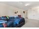 Bedroom featuring neutral carpet, a window, and a large closet at 36129 E Eldorado Lake Dr, Eustis, FL 32736