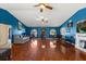 Expansive living room with hardwood floors and blue walls at 36129 E Eldorado Lake Dr, Eustis, FL 32736