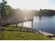 Scenic lake view with a wooden dock at 3700 Castle Pines Ln # 4032, Orlando, FL 32839