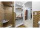 Updated bathroom features a walk-in shower, built-in shelving, and brick tile at 409 San Sebastian Prado, Altamonte Springs, FL 32714