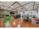 Spacious living room features hardwood floors, a dining area, and a wood-paneled wall at 409 San Sebastian Prado, Altamonte Springs, FL 32714