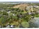 Wide aerial showcasing home, pool, dock, and surrounding landscape near lake at 41235 Silver Dr, Umatilla, FL 32784