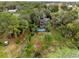 Aerial view of home with pool, dock, and lush landscaping near the lake at 41235 Silver Dr, Umatilla, FL 32784