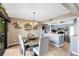 Dining area with a wooden table and chairs, adjacent to the kitchen at 41235 Silver Dr, Umatilla, FL 32784