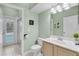 Clean bathroom with single sink vanity, toilet and shower access to pool at 4549 Saddleworth Cir, Orlando, FL 32826