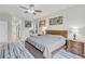 Bright bedroom with large window, ceiling fan, and ensuite bathroom at 4549 Saddleworth Cir, Orlando, FL 32826