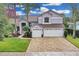 Two-story house with a light purple exterior, a brown roof, and a brick driveway at 4549 Saddleworth Cir, Orlando, FL 32826