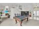 Spacious game room with a pool table, fireplace, and high ceilings at 4549 Saddleworth Cir, Orlando, FL 32826