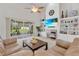 Bright living room with a fireplace, built-in shelving, and sliding doors to a patio at 4549 Saddleworth Cir, Orlando, FL 32826