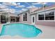 Inviting swimming pool with a screened enclosure and patio furniture at 4549 Saddleworth Cir, Orlando, FL 32826