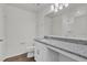 Bathroom featuring a granite countertop, white cabinetry, and a toilet for convenience at 5571 Creek Haven Way, Lakeland, FL 33810