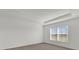 Bedroom showcasing natural light, neutral carpet, and a tray ceiling at 5571 Creek Haven Way, Lakeland, FL 33810