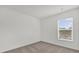 Neutral bedroom showing a window bringing in natural light and carpeted flooring at 5571 Creek Haven Way, Lakeland, FL 33810