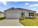 Charming single-story home featuring a two-car garage and well-manicured front yard at 5571 Creek Haven Way, Lakeland, FL 33810