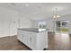 Bright living area featuring wood-look floors, recessed lighting, sliding glass doors, and a ceiling fan at 5571 Creek Haven Way, Lakeland, FL 33810