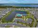 Aerial view of community pool, lake, and homes at 627 Bayhawk St, Debary, FL 32713