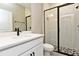 Modern bathroom with white vanity, black accents, and hexagon tile floor at 627 Bayhawk St, Debary, FL 32713