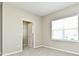 Bedroom with neutral walls, carpet flooring and a large window at 627 Bayhawk St, Debary, FL 32713