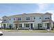 Three attached townhouses featuring light blue siding and gray accents at 627 Bayhawk St, Debary, FL 32713