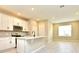 Modern kitchen with white cabinets, quartz countertops, and stainless steel appliances at 627 Bayhawk St, Debary, FL 32713