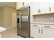 Stainless steel refrigerator in a modern kitchen with white cabinets at 627 Bayhawk St, Debary, FL 32713