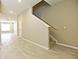 Modern staircase with carpeted steps and wood-look tile flooring at 627 Bayhawk St, Debary, FL 32713