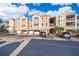 Front view of a multi-unit residential building with parking at 6413 Astor Village Ave # 305, Orlando, FL 32835