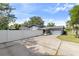 House exterior with driveway and white vinyl fence at 680 Avenue N Se, Winter Haven, FL 33880