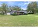 Grey house with attached garage and large backyard at 680 Avenue N Se, Winter Haven, FL 33880