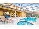 Enclosed pool and spa with lounge chairs; backyard oasis at 7619 Oakmoss Sw Loop, Davenport, FL 33837