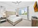 Main bedroom with plush bed, large window, and modern decor at 7740 Sandy Ridge Dr # 111, Reunion, FL 34747