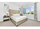 Main bedroom with plush bed, large window, and modern decor at 7740 Sandy Ridge Dr # 111, Reunion, FL 34747