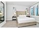 Main bedroom with plush bed and large mirror at 7740 Sandy Ridge Dr # 111, Reunion, FL 34747