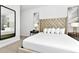 Elegant bedroom with large bed and mirrored wall at 7740 Sandy Ridge Dr # 111, Reunion, FL 34747