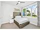 Bedroom with plush bed, large window, and modern decor at 7740 Sandy Ridge Dr # 111, Reunion, FL 34747