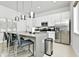 Modern kitchen with island, stainless steel appliances, and gray countertops at 7740 Sandy Ridge Dr # 111, Reunion, FL 34747