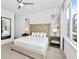 King-size bed with tufted headboard, nightstands, and large window at 7740 Sandy Ridge Dr # 111, Reunion, FL 34747