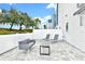 Private patio with gray couch and lounge chairs at 7740 Sandy Ridge Dr # 111, Reunion, FL 34747