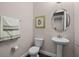 Powder room with pedestal sink and toilet at 8547 Bayview Crossing Dr, Winter Garden, FL 34787