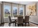 Bright dining room with large windows and modern chandelier at 8547 Bayview Crossing Dr, Winter Garden, FL 34787